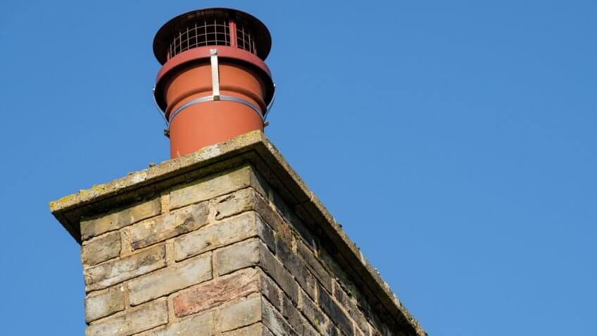 The cap on the chimney prevents birds from nesting in the smoke stack, as the household has a real fire and thus helps prevent any fire issues.