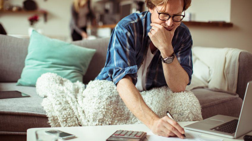 Close up of a mature man paying bills.