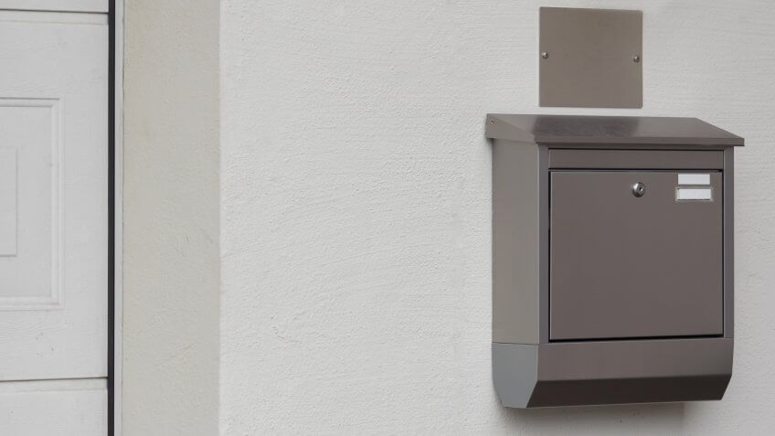 A silver mailbox on the wall.