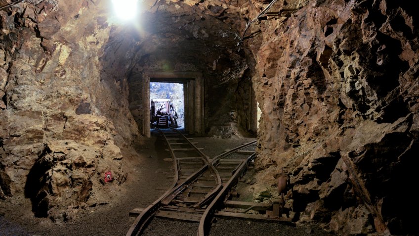Old dark dangerous mine corridor.