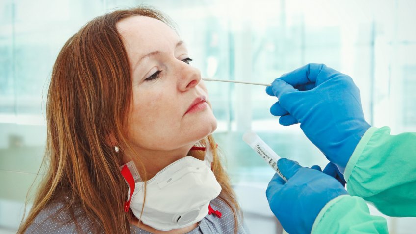 Medic taking sample from patients nose for coronavirus testing.