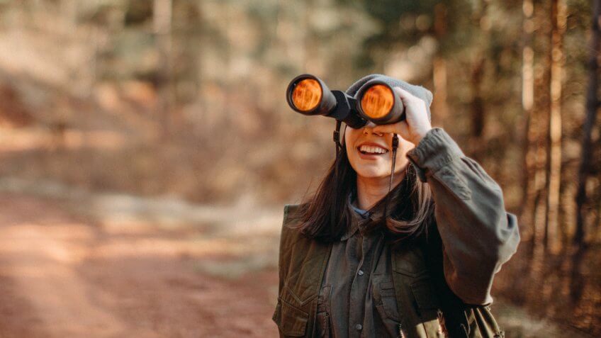 Woman looking through binoculars.