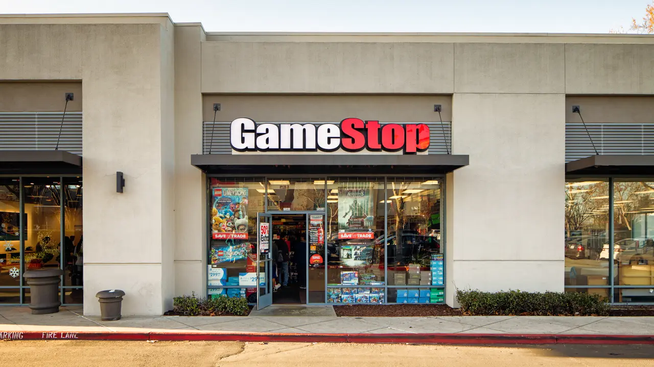 Gamestop video games store entrance facade in strip mall with sign, photographed in San Jose, California on boxing day.