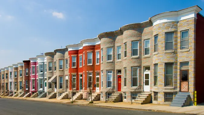 Colorful row houses along a sunny residential street.