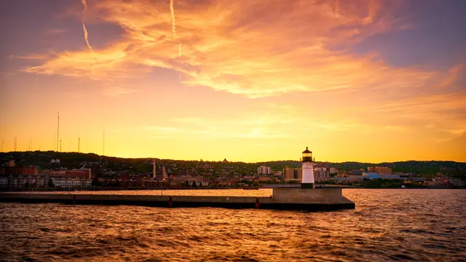 Beautiful sunset at Duluth Canal Park Lighthouse with the background of Duluth Downtown.