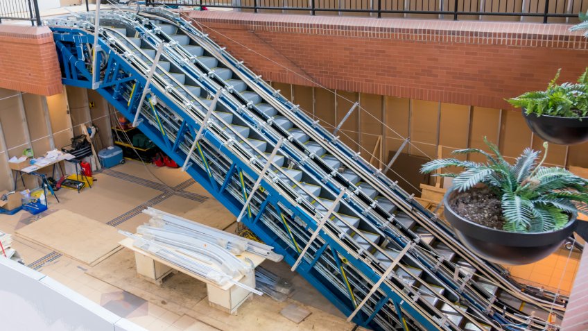 An escalator being installed inside a building.