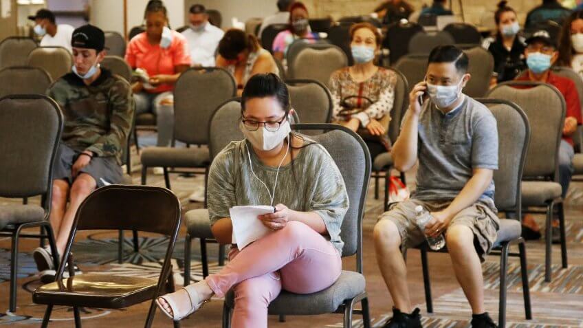Mandatory Credit: Photo by Sue Ogrocki/AP/Shutterstock (10706877b)People wait to speak with representatives from the Oklahoma Employment Security Commission about unemployment claims, in Midwest City, Okla.