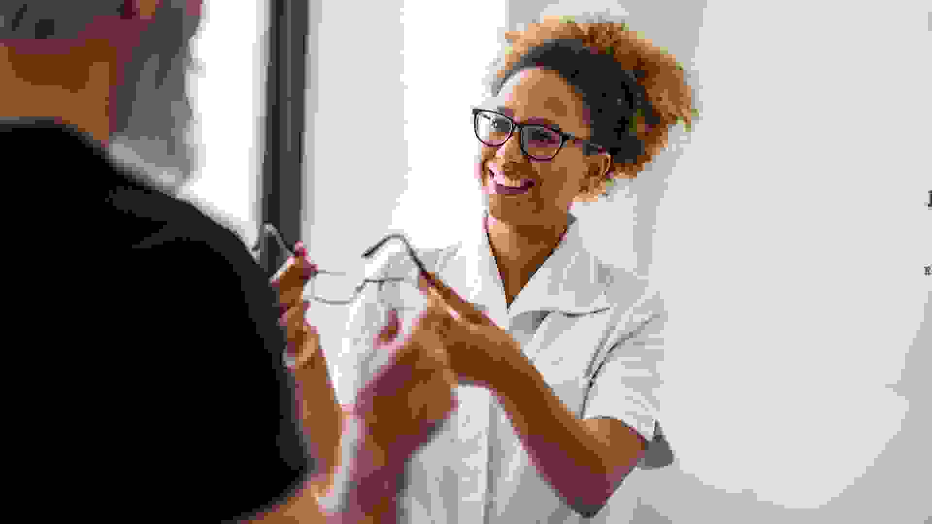 Portrait of a young female doctor talking to her client about eyesight.
