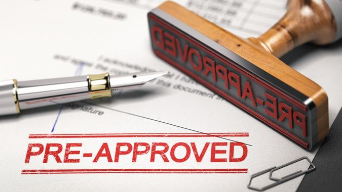 Printed document with rubber stamp and the word pre-approved.