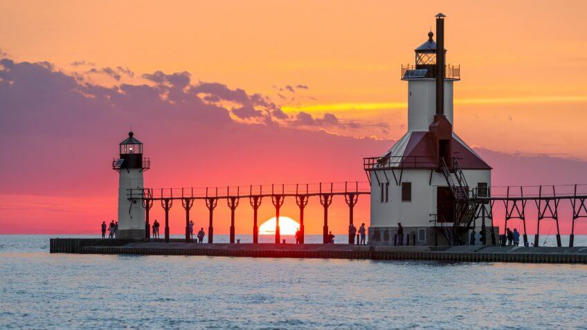 On the Summer Solstice, the sun sets on Lake Michigan between the Inner and Outer North Pier Lighthouses at St.