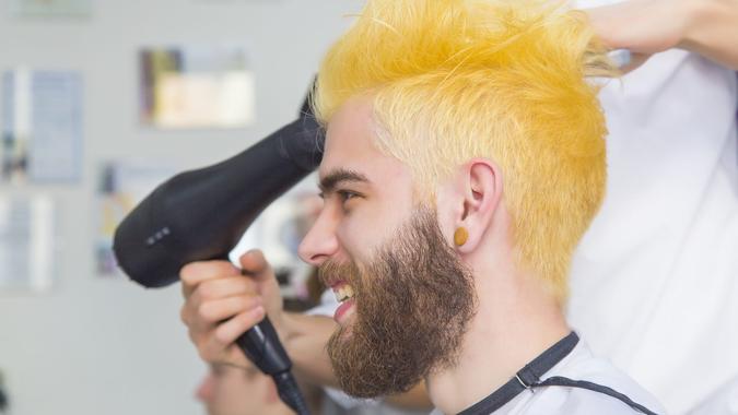 In the making of a dyed blond hair for a bearded hipster guy.