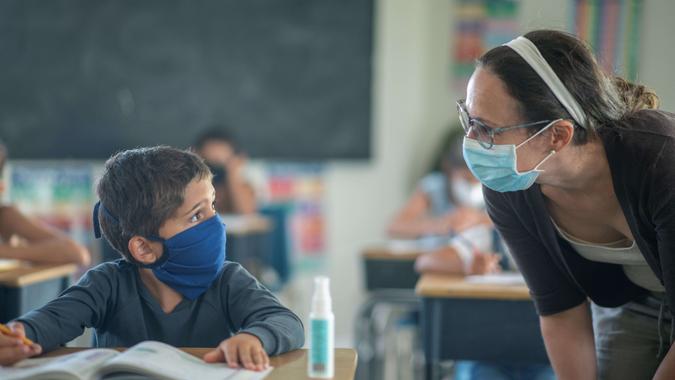Students in the classroom are wearing protective masks during coronavirus pandemic.