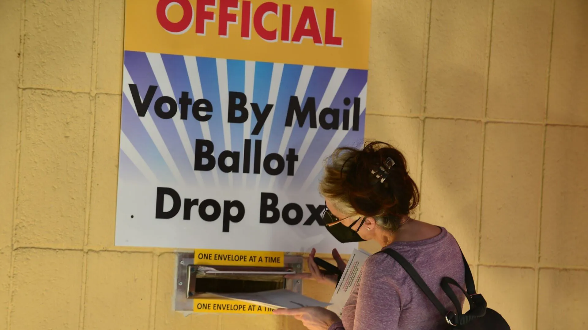 Mandatory Credit: Photo by JLN Photography/Shutterstock (10748887p)Voter drop their ballot at the drop box at Broward County Supervisor of Election Headquarters in Lauderhill, Florida, U.