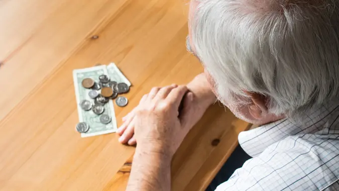 poor senior closeup at home sit problems with money no food alone