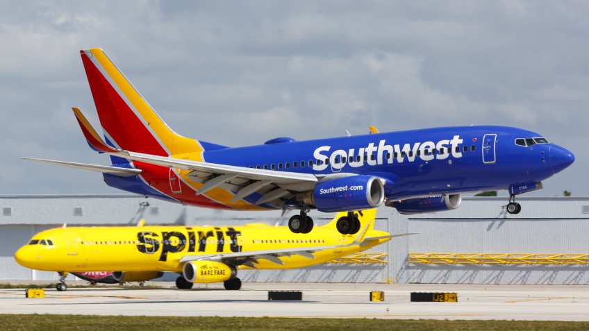 Southwest plane landing with Spirit plane in the background