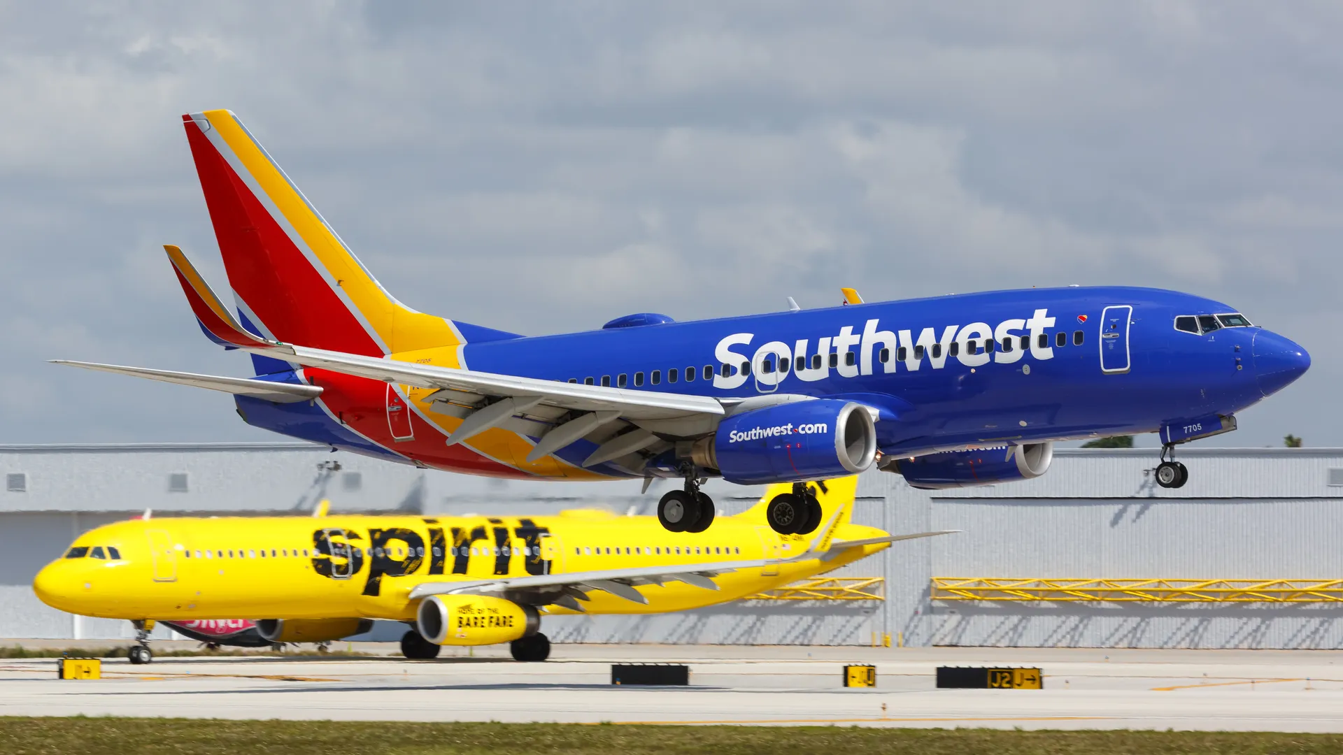 Southwest plane landing with Spirit plane in the background
