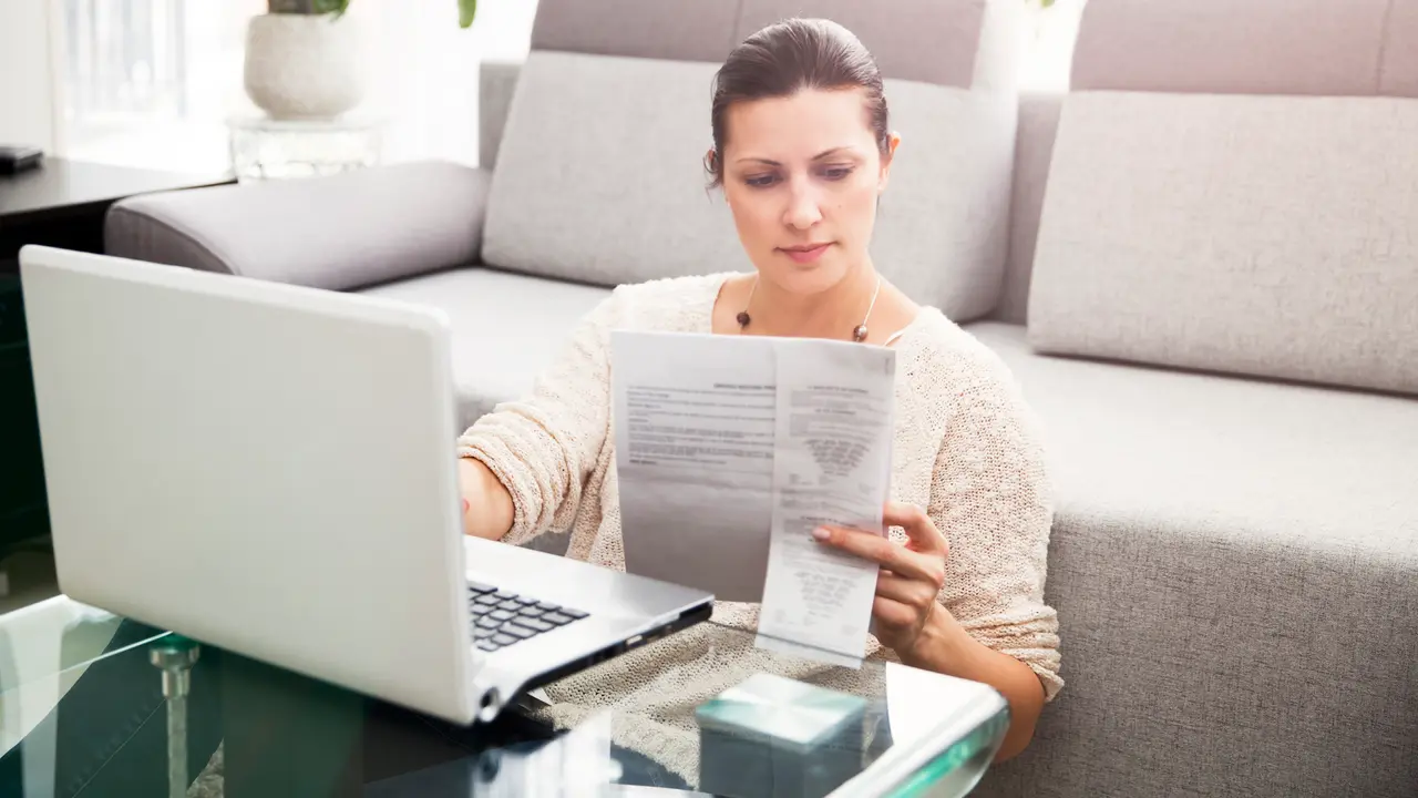 Woman in her 30s filling out tax information online.