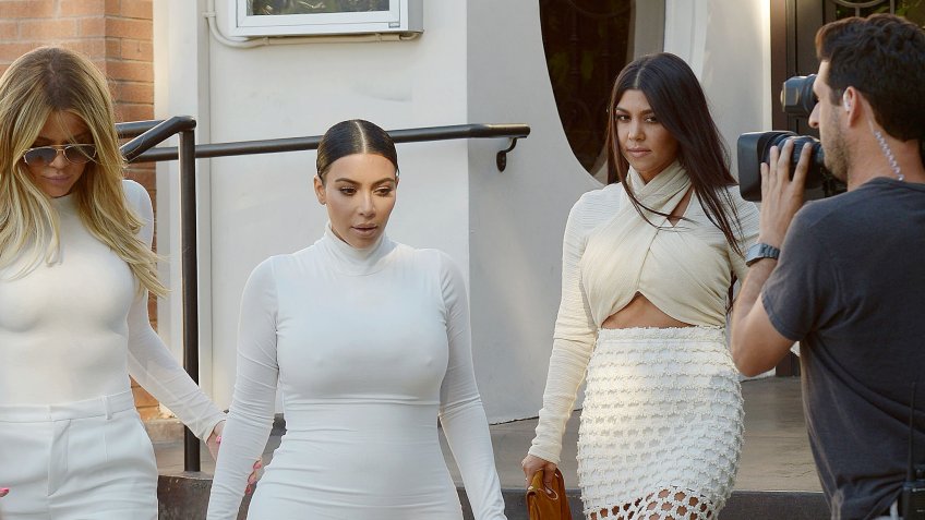 Mandatory Credit: Photo by Broadimage/Shutterstock (4898647g)Khloe Kardashian, Kim Kardashian West, Kourtney KardashianThe Kardashians out and about, Los Angeles, America - 07 Jul 2015Kim Kardashian shows off her growing baby bump in an extremely tight white dress while leaving Casa Escobar.