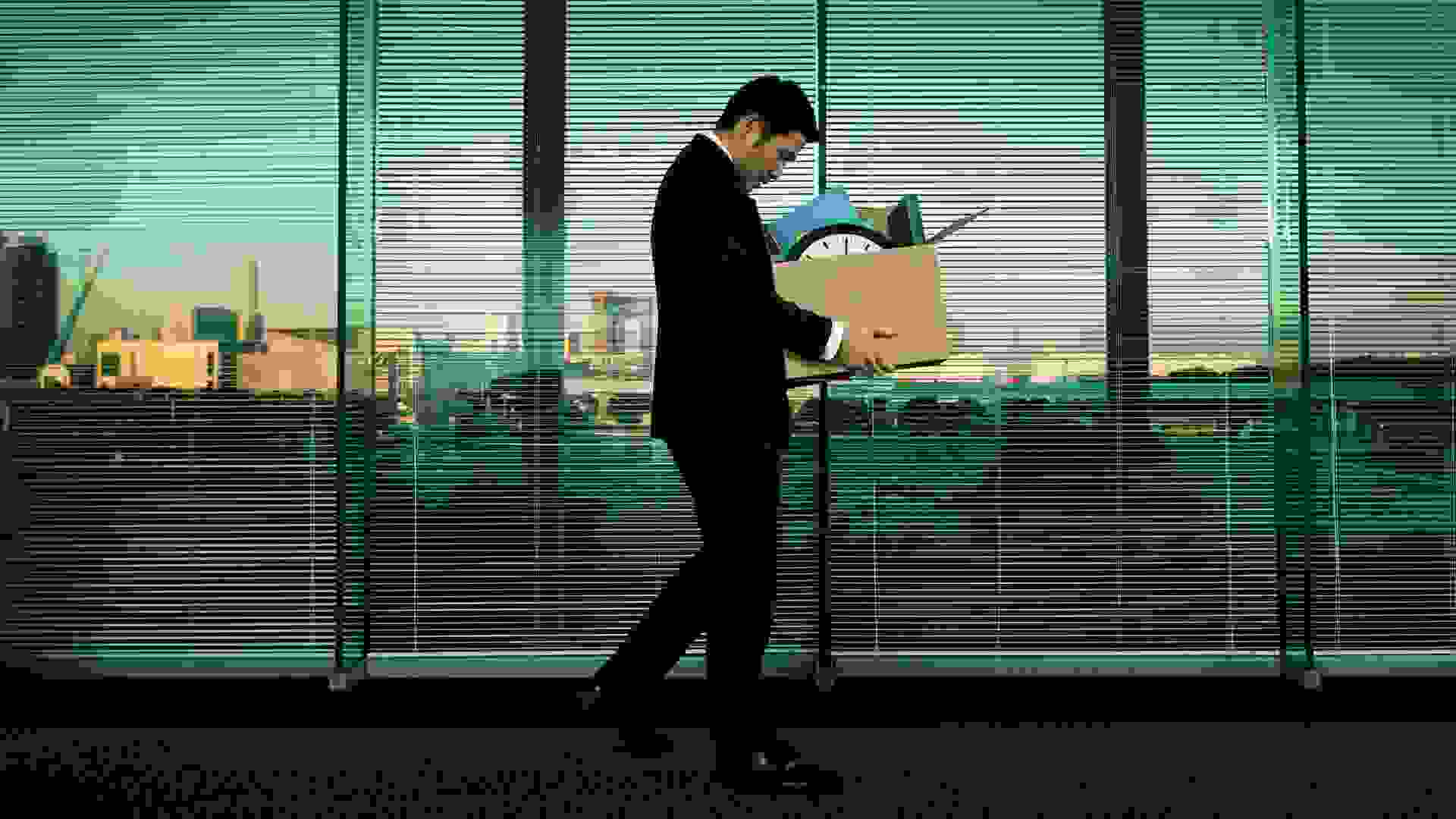 Subject: A Japanese business office worker leaving his job with all his belonging in a layoff and economic recession.