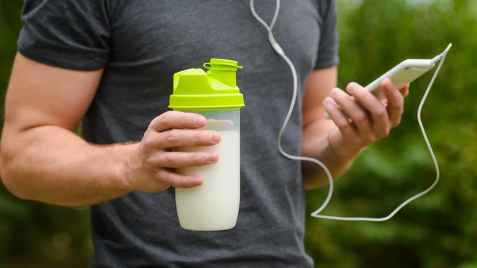 https://cdn.gobankingrates.com/wp-content/uploads/2020/11/fitness-man-protein-drink-shake-iphone-headphones_shutterstock_536628133.jpg?w=675&quality=75