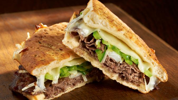 Philadelphia Cheesesteak Flatbread or Panini sandwich made with steak, provolone cheese and saute onions and bell peppers.