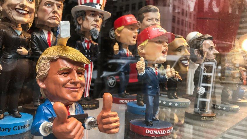 New York, 5/23/2019: Bobble head dolls of various political figures are seen on a gift shop's window display.