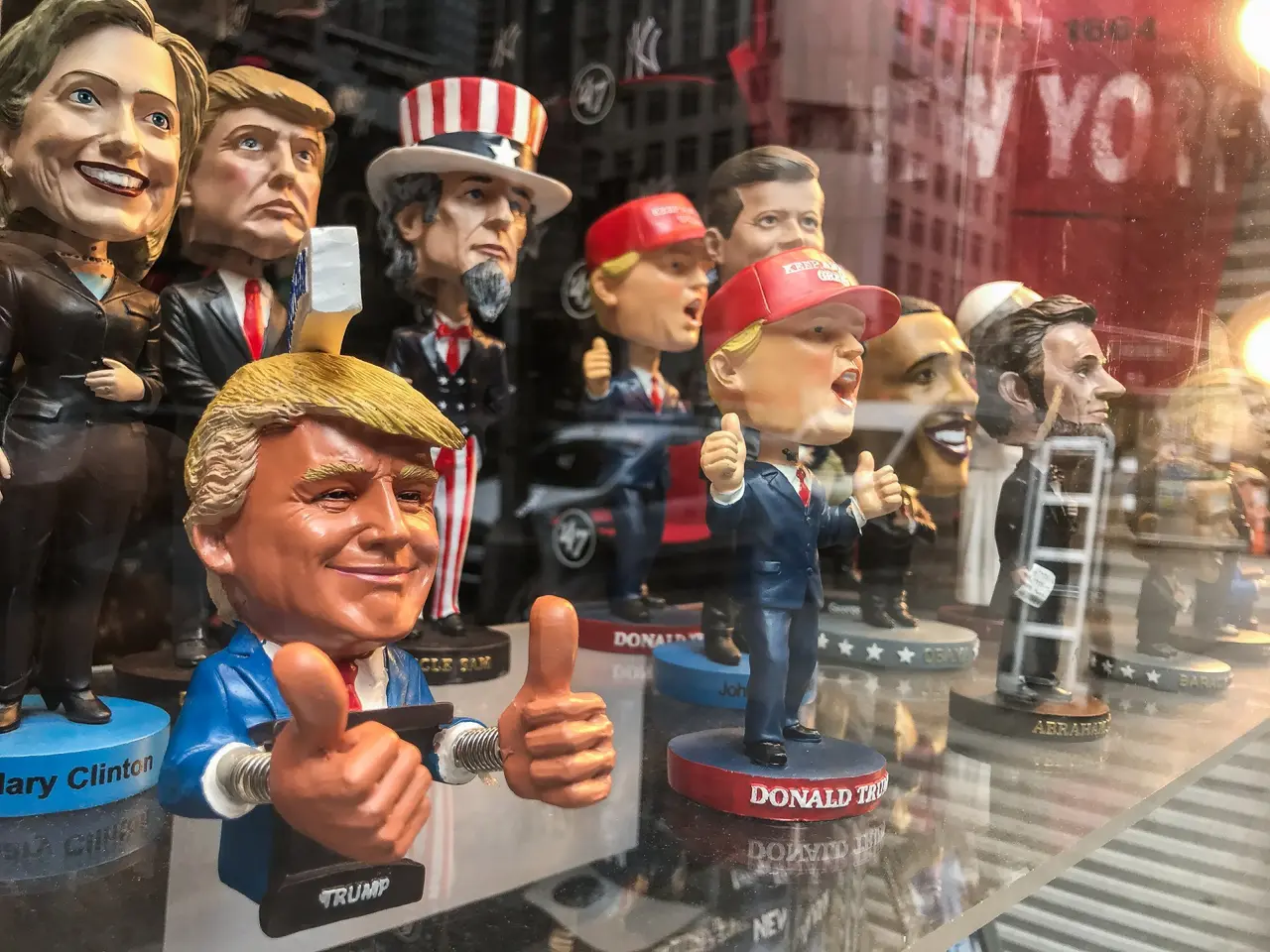 New York, 5/23/2019: Bobble head dolls of various political figures are seen on a gift shop's window display.