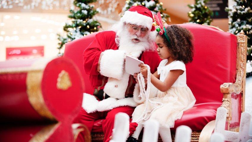 Shopping Christmas with family and Santa Claus at Shopping Mall stock photo