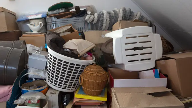Pile of junk in a house, hoarder room pile of household equipment needs clearing out storage.