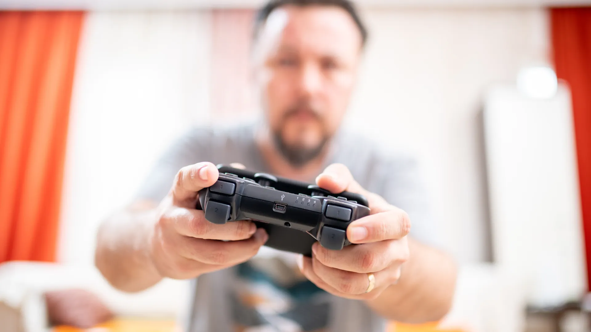 man holding game controller playing video games