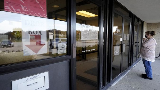 Mandatory Credit: Photo by Nam Y Huh/AP/Shutterstock (11002151e)Woman checks information as information signs are displayed at IDES (Illinois Department of Employment Security) WorkNet center in Arlington Heights, Ill.