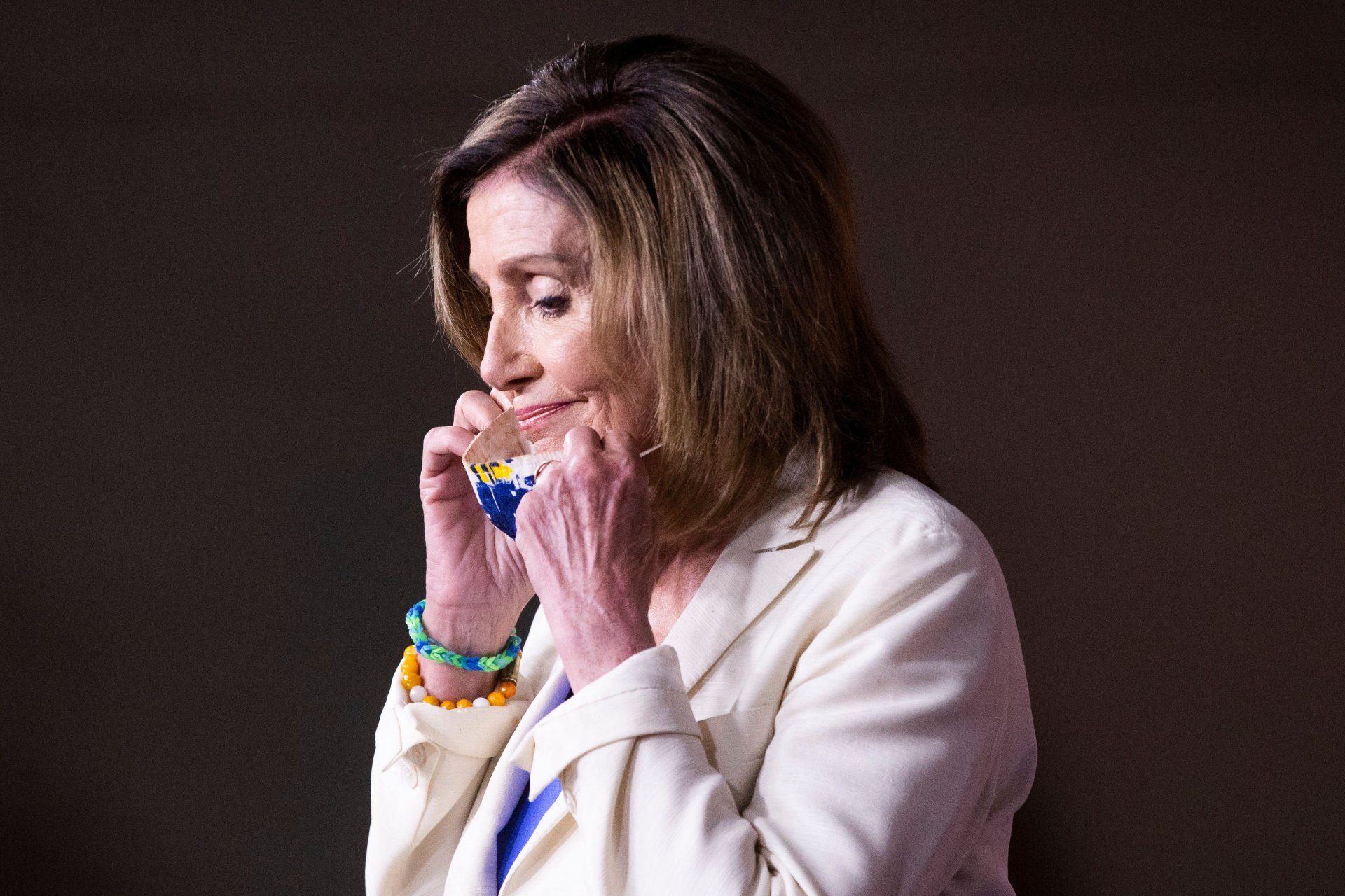 Mandatory Credit: Photo by MICHAEL REYNOLDS/EPA-EFE/Shutterstock (10713718e)US Speaker of the House Nancy Pelosi removes a face mask upon arriving at a news conference on Capitol Hill in Washington, DC, USA, 16 July 2020.
