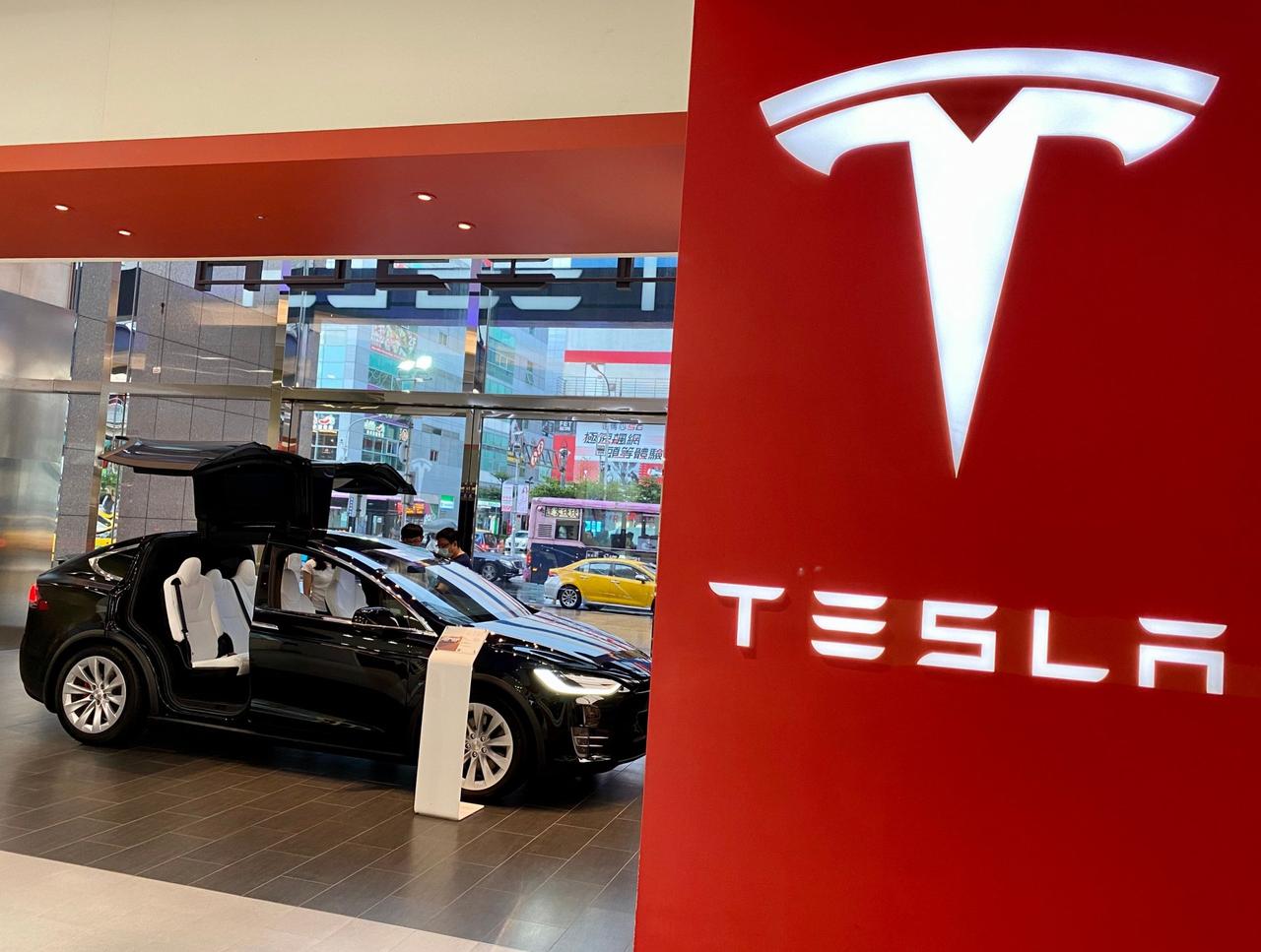 Mandatory Credit: Photo by RITCHIE B TONGO/EPA-EFE/Shutterstock (10724187c)People check the interior of Tesla Model X car on display inside a Tesla showroom in Taipei, Taiwan, 27 July 2020.