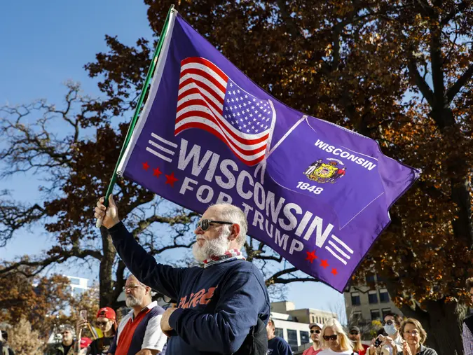 Mandatory Credit: Photo by CHINE NOUVELLE/SIPA/Shutterstock (11007653m)A supporter of Donald Trump holds a flag at a rally in Madison, Wisconsin, the United States, on Nov.