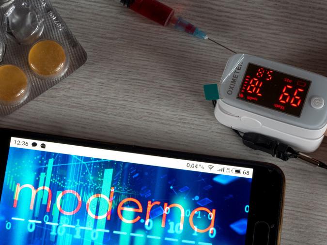 Mandatory Credit: Photo by Valera Golovniov/SOPA Images/Shutterstock (11064090j)In this photo illustration a Moderna logo seen displayed on a smartphone next to pills, a syringe and an oximetre.
