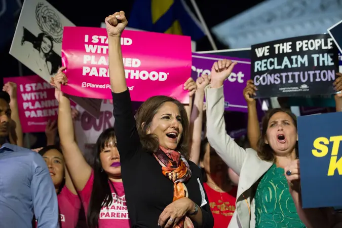Mandatory Credit: Photo by Cliff Owen/AP/Shutterstock (9747935d)Neera Tanden, president, Center for American Progress, center, rallies in front of the Supreme Court in Washington, after President Donald Trump announced Judge Brett Kavanaugh as his Supreme Court nomineeTrump Supreme Court, Washington, USA - 09 Jul 2018.