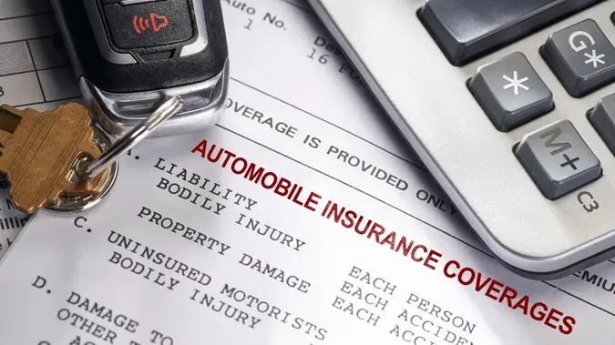 Car and car insurance with keys and calculator.