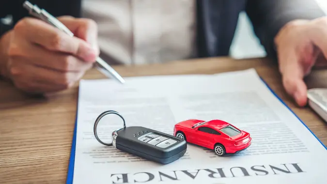 Sale agent  deal to agreement successful car loan contract with customer and sign agreement contract  Insurance car concept.
