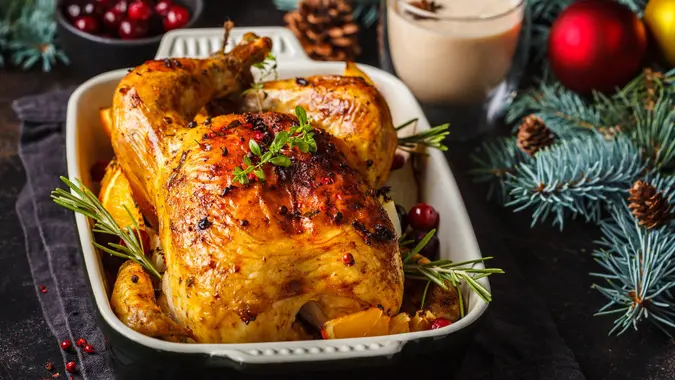 Christmas baked chicken with cranberries, orange, spices and herbs. Christmas food concept. stock photo