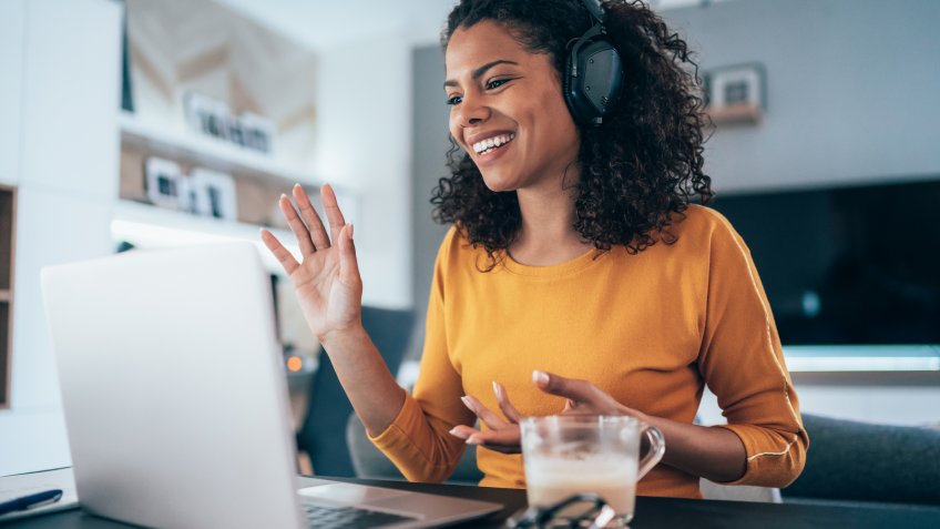 Young modern woman having Video Conference at home.