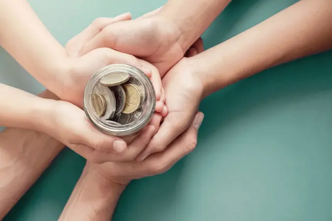 child and parent hands holding money jar, donation, saving, charity, family finance plan concept, Coronavirus economic stimulus rescue package, superannuation concept.