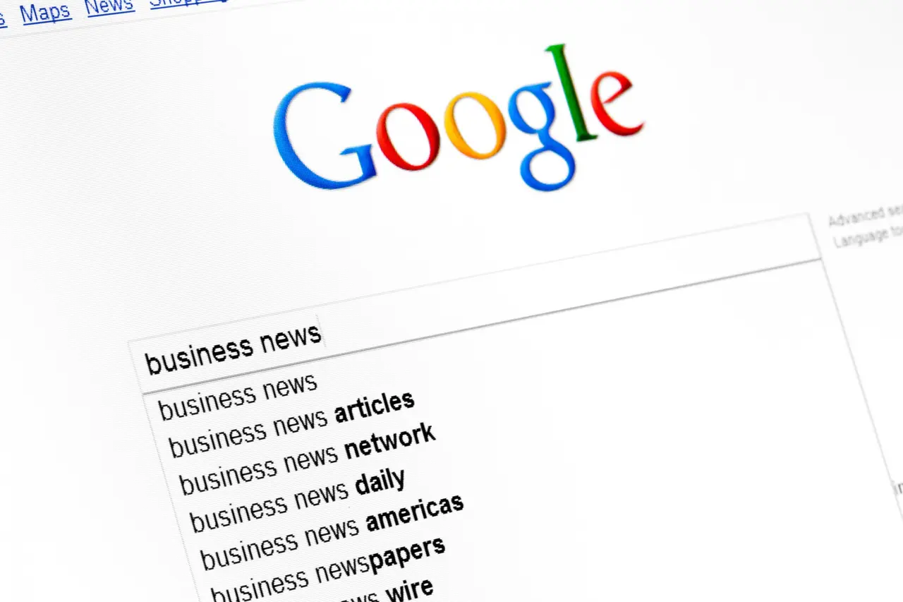 Kyiv, Ukraine - March 13, 2011: Business news text string in google search field start page.