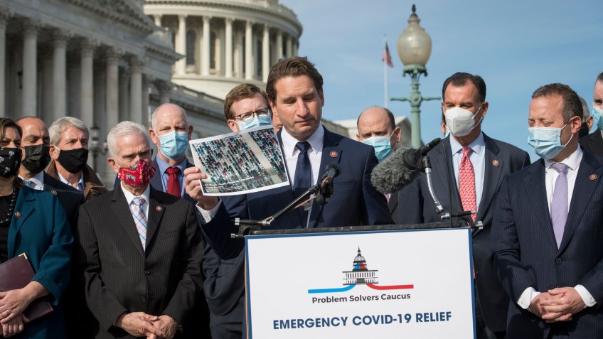 Mandatory Credit: Photo by Shutterstock (11121661y)United States Representative Dean Phillips (Democrat of Minnesota) holds up photos which he says are of people waiting in long lines to get free food, as he offers remarks while joined by members the Problem Solvers Caucus during a press conference on the need for bipartisan and bicameral COVID-19 relief, outside of the U.