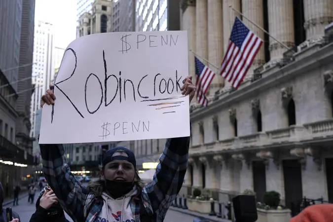 Mandatory Credit: Photo by John Lamparski/SOPA Images/Shutterstock (11734562f)A demonstrator holds up a placard saying Robin Crook in front of the New York Stock Exchange.