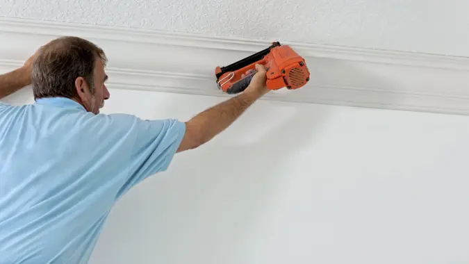 carpenters installing crown molding.