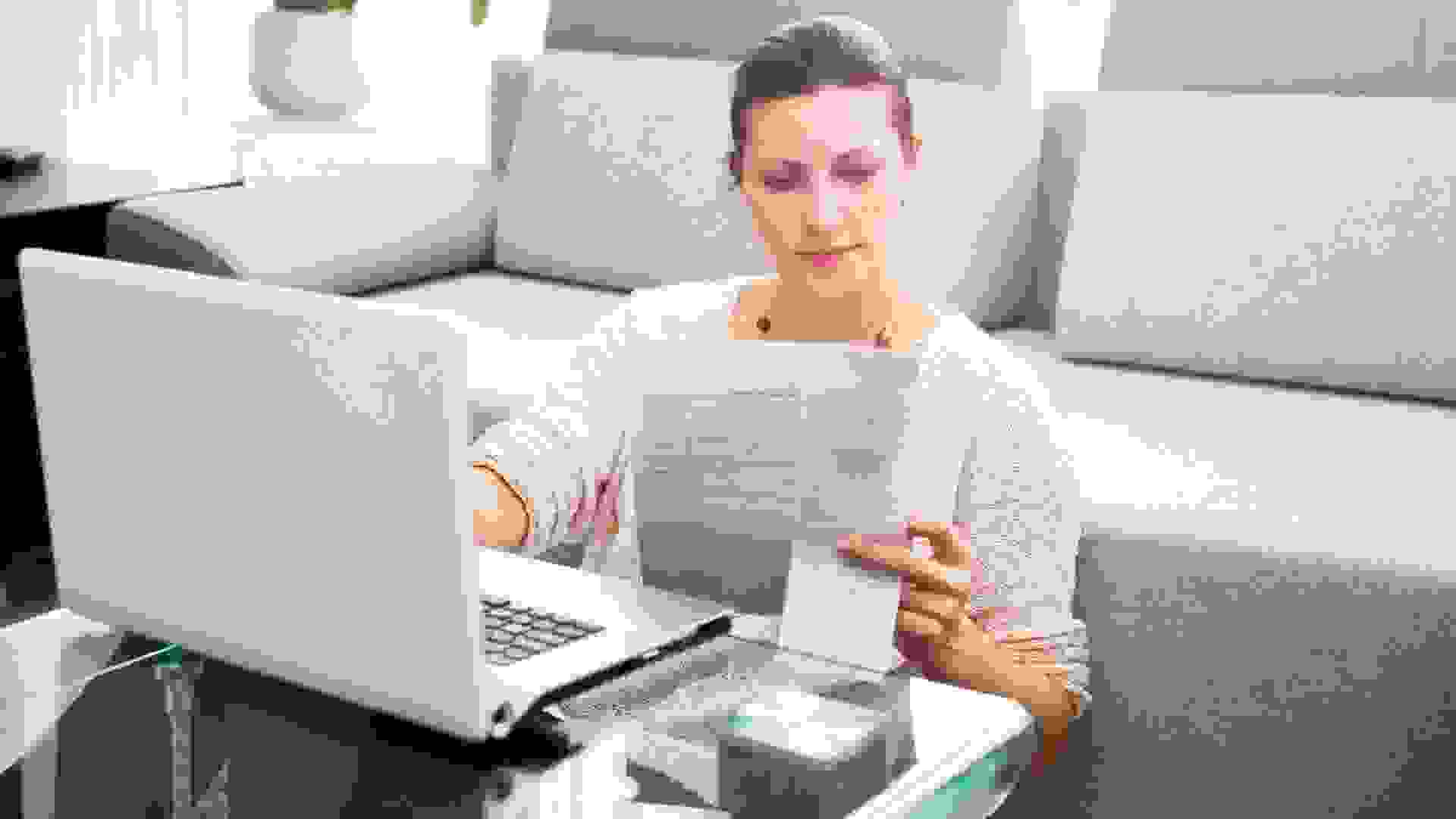 Woman in her 30s filling out tax information online.