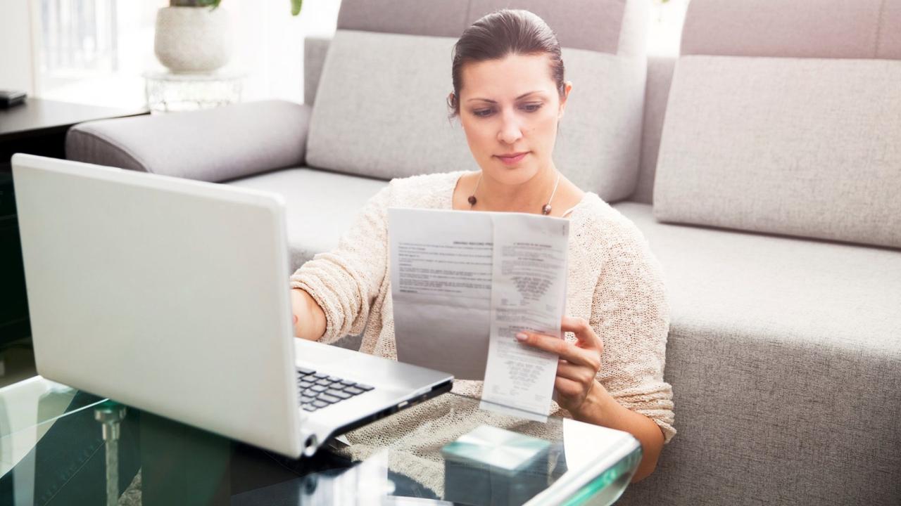 Woman in her 30s filling out tax information online.