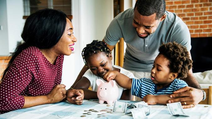 Family saving money to piggy bank.