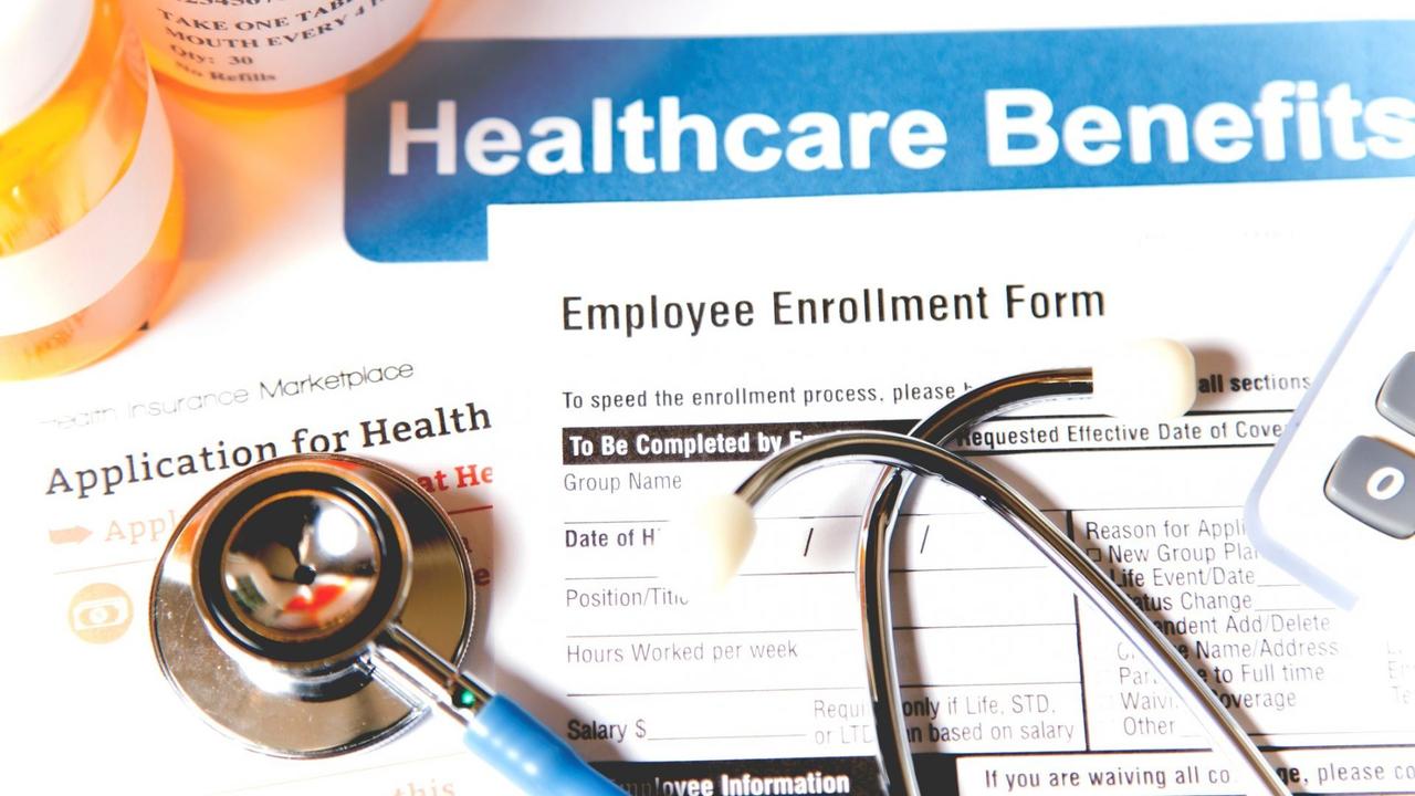 Healthcare benefit forms including: enrollment forms and applications, stethoscope, calculator.