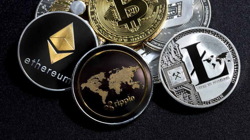 izmir, Turkey - September 28, 2018 Close up ethereum ripple litecoin bitcoin dash coins shot in metallic black background in studio.